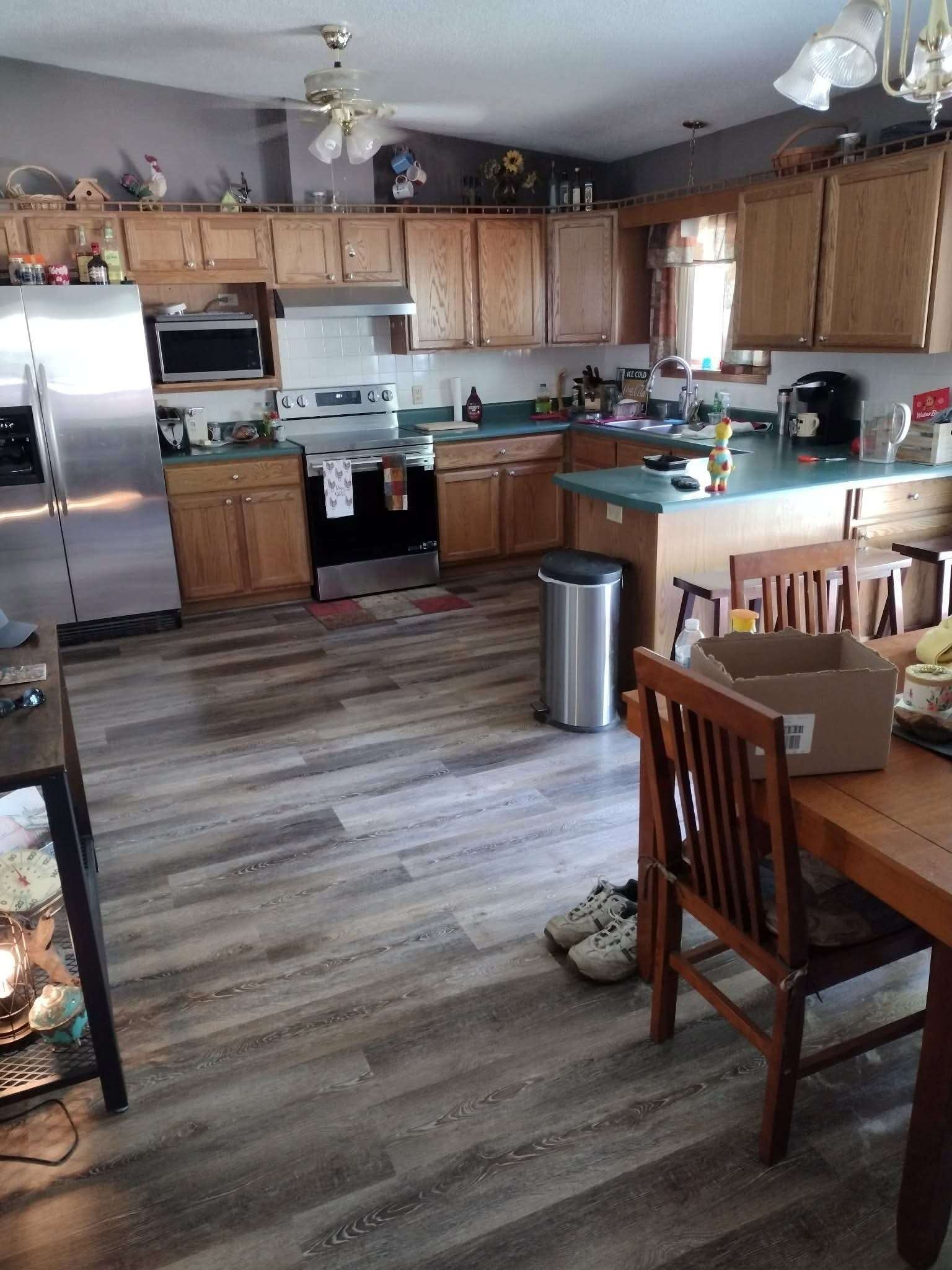 Kitchen before — dated honey oak cabinets and teal countertops